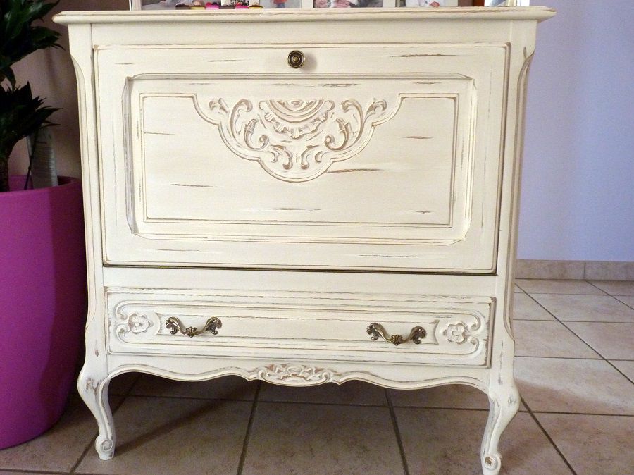 Le meuble était vernis, après décapage, ponçage et nettoyage, je l'ai peint avec une peinture acrylique blanc puis poncé pour laisser des traces d'usure aux endroits de frottements et sur les moulures, il a été patiné à la cire incolore.